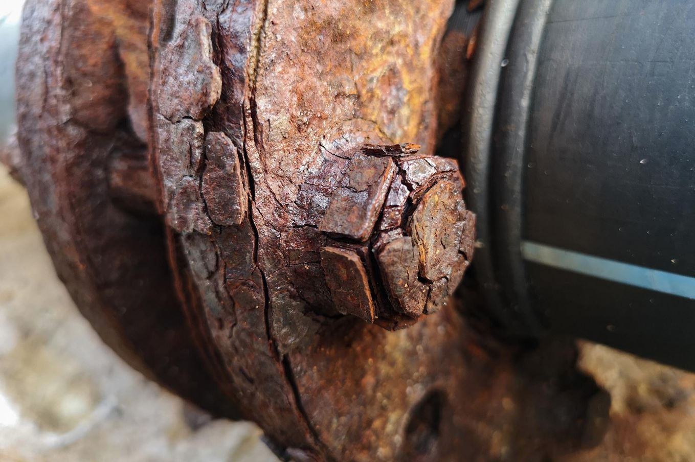 Rusted metallic sculpture producing harmonic vibrations in soft amber light